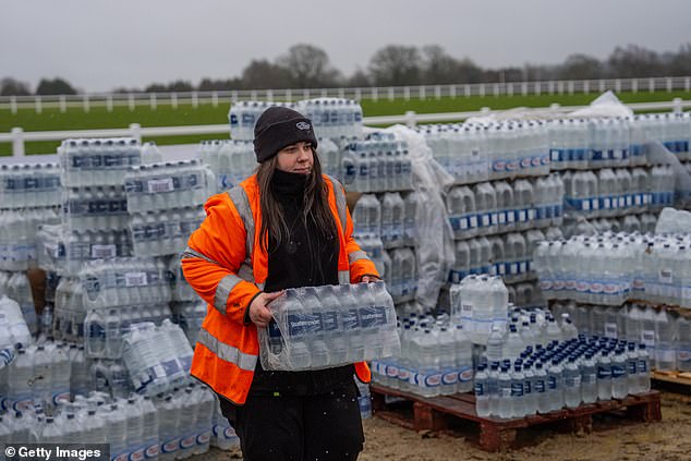 Bottled water is loaded into a car at an emergency water distribution point in Tunbridge Wells