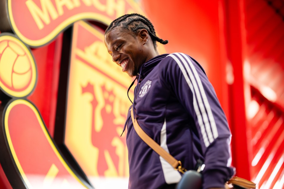 Tyrell Malacia smiling while arriving at the stadium.