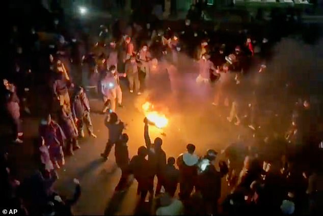 Protesters dancing and cheering around a bonfire in Tehran on January 9