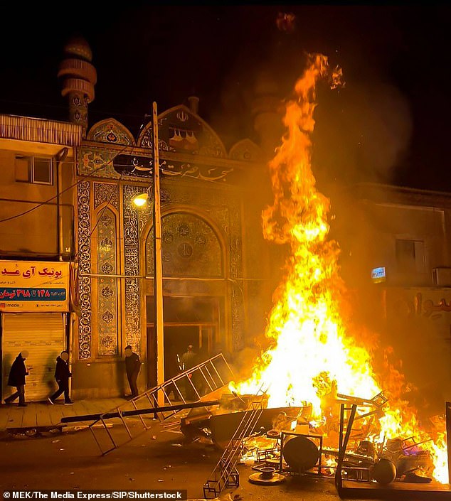 Protesters set fire to makeshift barricades near a religious centre on January 10