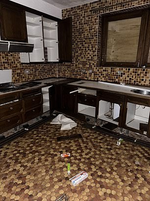 The floors of the once impressive mansion can be seen covered in rubbish and debris