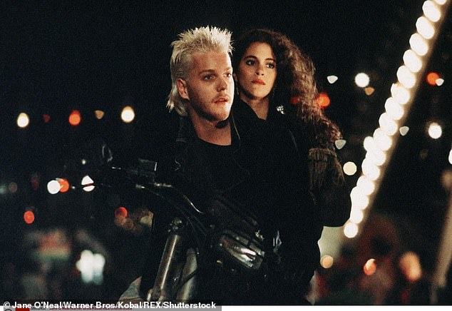 His profile increased substantially with Joel Schumacher's teen vampire film The Lost Boys (1987), and other early films included 1988's Young Guns, as well as Flatliners (1990), which paired him with Julia Roberts and Kevin Bacon; pictured in The Lost Boys with Jami Gertz