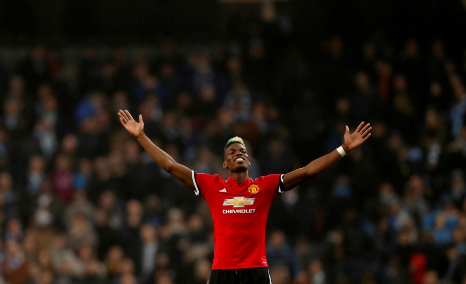 Manchester United midfielder Paul Pogba celebrates with arms outstretched.