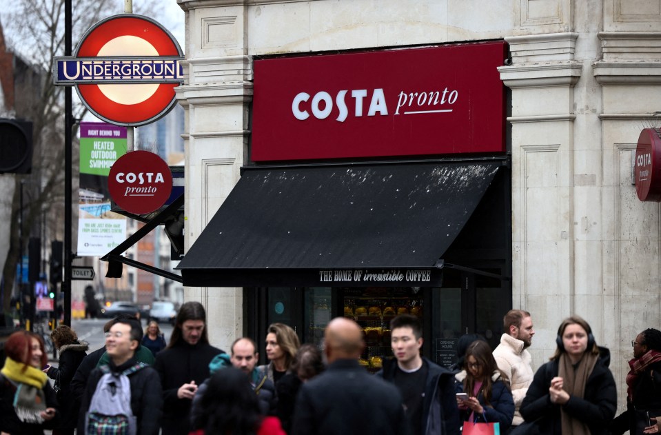 People walk outside a Costa Coffee shop in London.