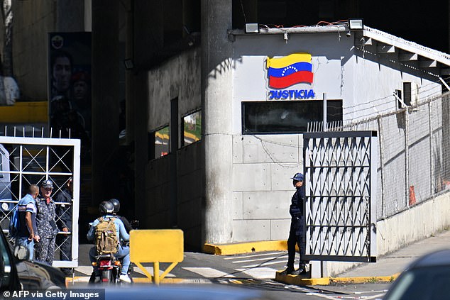 An officer stands guard at the entrance to El Helicoide -a facility and prison owned by the Venezuelan government and used for both regular and political prisoners of the Bolivarian National Intelligence Service (SEBIN)- in Caracas on January 9, 2026
