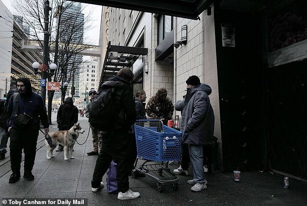 Vagrants gathered by McDonald's in Seattle with shopping carts. The restaurant, nicknamed by locals as McStabby's, initially closed its dining room to comply with Covid social distancing measures but never reopened it even after the pandemic ended
