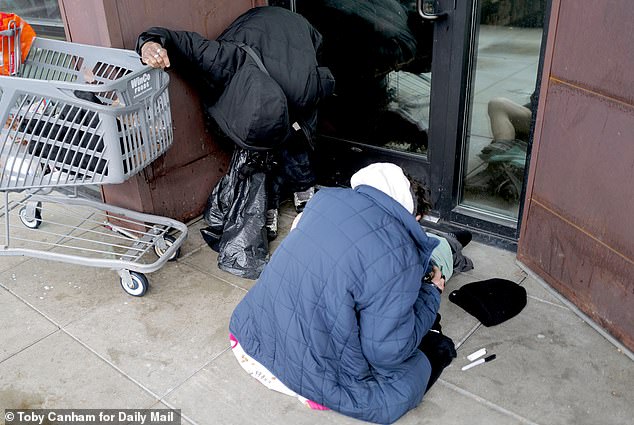 Drug users folded over on the street in Downtown Seattle, where open-air drug use appears prominent