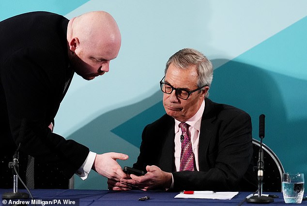 Nigel Farage seemed to be alerted to the breaking news by a press officer as he was unveiling the party's new leader in Scotland