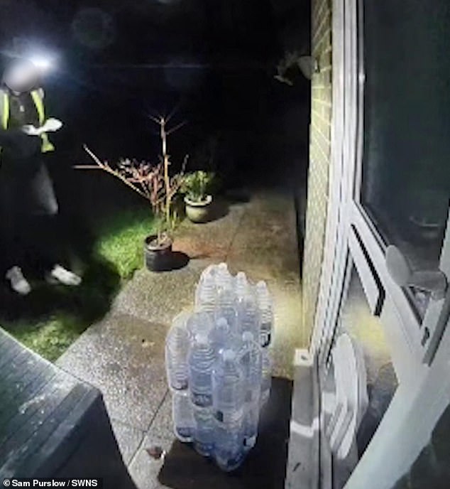 The man can be seen delivering four cases of bottled water and taking a picture - before picking it back up again and walking away moments after