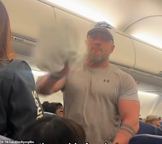 The moment quickly grew physical as the crazed flyer was seen hurling his to-go food at another passenger before being booted off the flight