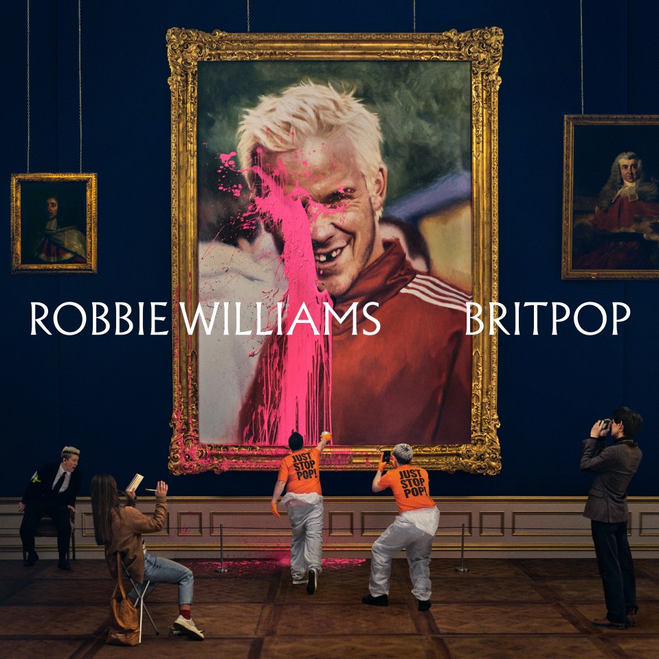 Robbie Williams album cover, Britpop, showing a smiling blonde man with hot pink paint splattered on his face, in a gold frame, with two people in orange shirts that say "Just Stop Pop" throwing paint at it.