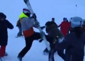 Moment snowboarders & skier brawl in the snow on mountain slope after argument breaks out following crash