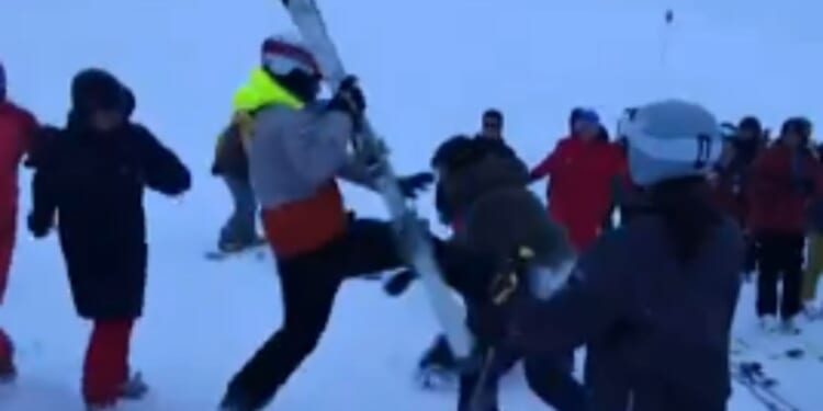 Moment snowboarders & skier brawl in the snow on mountain slope after argument breaks out following crash