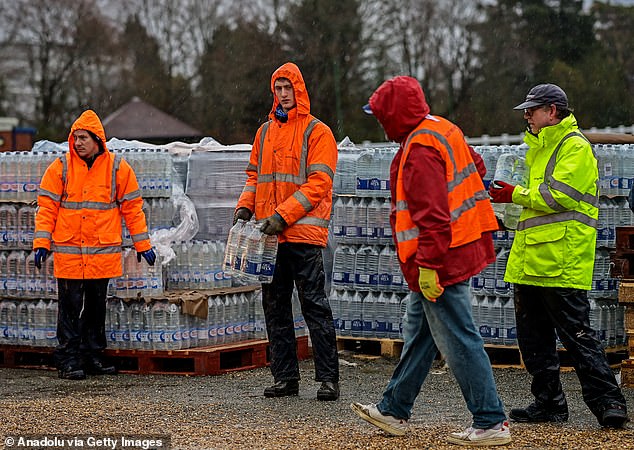 Workers at a bottled water station for those impacted by outages in Tunbridge Wells on Thursday