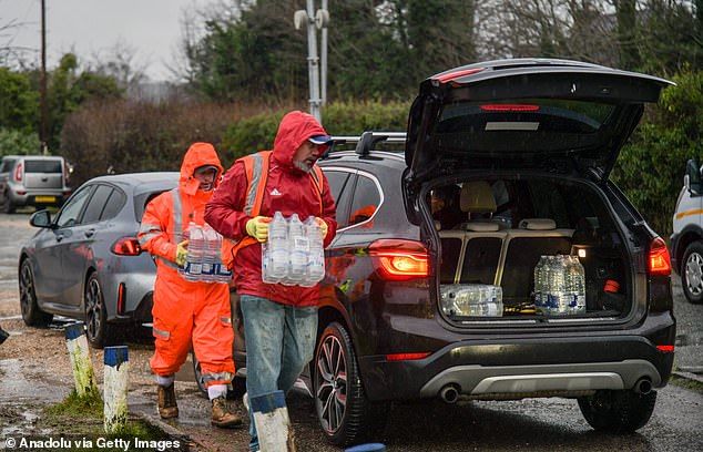 Officials distribute bottled water in Tunbridge Wells, Kent, as thousands of properties across South East England remain affected by water outages on Thursday