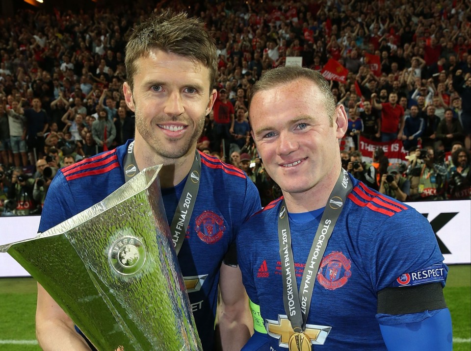 Michael Carrick and Wayne Rooney celebrate with the UEFA Europa League trophy.