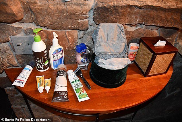 A gray pull-up diaper could be seen in a black pot on this wood table