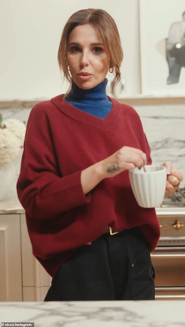 The singer, 42, filmed the playful short clip in a blue turtleneck over an golden V-neck jumper, which she paired with black jeans as she wore her hair up in a low bun