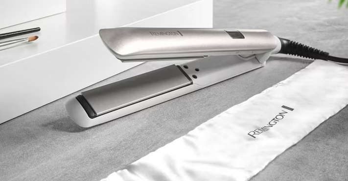 Remington hair straighteners with a branded white heat protection pouch.
