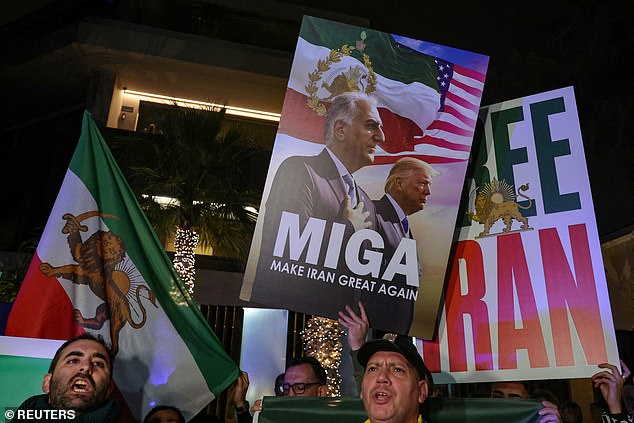 An Iranian holds a placard depicting Reza Pahlavi, the son of Iran's last shah and an Iranian opposition figure outside an Iranian embassy in Athens
