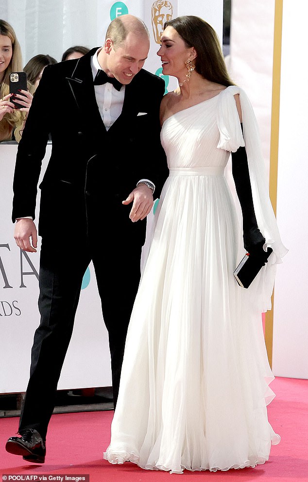 Ms James suggests that Kate playfully taps William as 'a playful reprimand for the refusal' to hold her hand