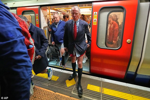 People walk off a London Underground train while wearing no trousers on Sunday