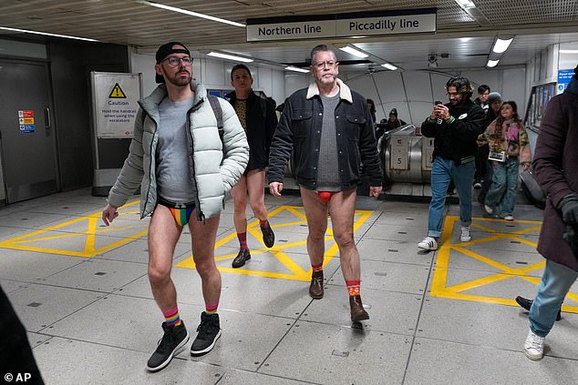 Passengers travel on the Underground during the annual 'No Trousers Tube Ride' on Sunday