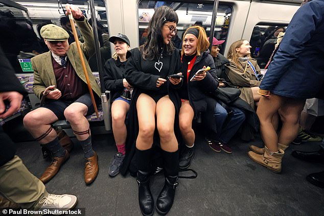 A group of people take part in the No Trousers Tube Ride on London's Elizabeth line on Sunday