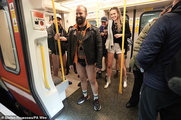 People laugh as they stand on an Underground train during Sunday's No Trousers Tube Ride