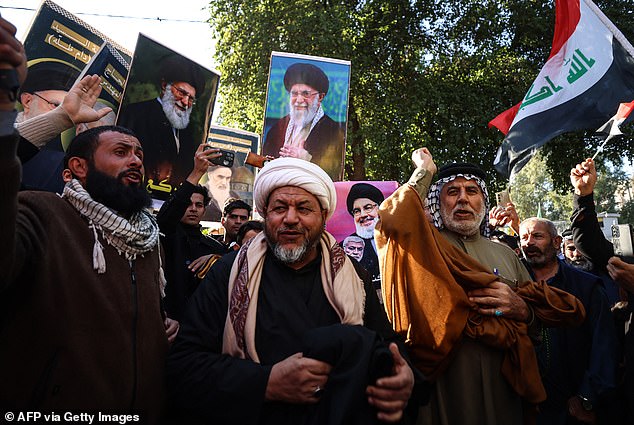 Protesters hold up portraits of Iran's Supreme Leader Ayatollah Ali Khamenei (top and left) during a demonstration near the Iranian embassy in Baghdad in support of the Iranian regime and its supreme leader