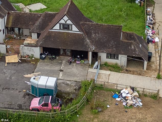 The home, pictured in May 2024, featured mounds of rubbish, a discarded horse box and Katie's now-legendary pink Range Rover