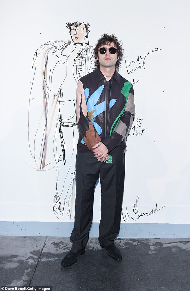 The son of Oasis legend Liam Gallagher, 26, slipped into a multi-coloured leather jacket as he posed up a storm inside the event