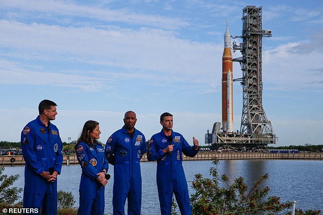 From L-R: Canadian Space Agency astronaut Jeremy Hansen stands alongside NASA astronauts Christina Koch, Victor Glover and Reid Wiseman. Wiseman will also serve as the mission's commander. The group of four address reporters with the rocket and spacecraft directly behind them