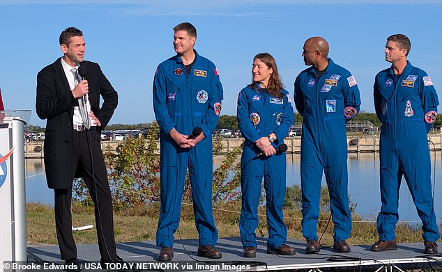 Pictured: NASA Administrator Jared Isaacman stands with the four astronauts during a press briefing