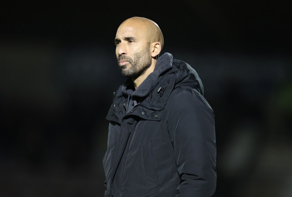 Huddersfield Town manager Lee Grant in a black coat looking left.