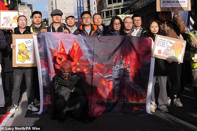 Representatives of the Inter-Parliamentary Alliance on China, along with other groups, demonstrate outside Royal Mint Court in London on Saturday