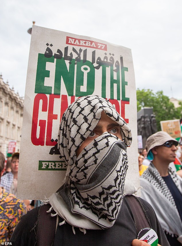 A Pro-Palestinian demonstrator is seen in Whitehall wearing a keffiyeh during a national demonstration for Palestine in June 2025