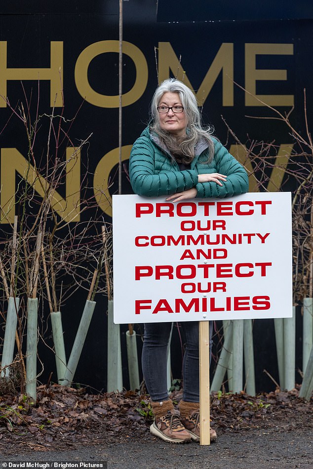 Locals held up placards to voice their disapproval of plans to house migrants in a former army barracks