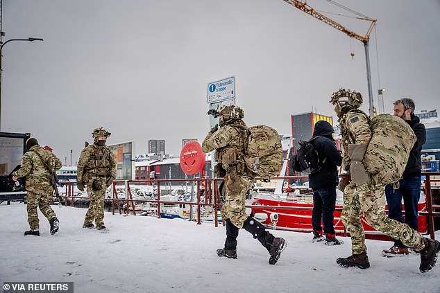 Danish soldiers in camo uniform disembark at the harbor in Nuuk, Greenland on January 18, 2026.