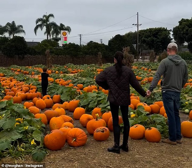 In footage from October, Meghan dons a pair of black knee-high boots and leggings with a black jacket while Harry opts for a casual look in jeans, a hoodie and a baseball cap. The pair can be seen holding hands