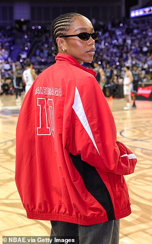 She completed the look with baggy jeans and shades