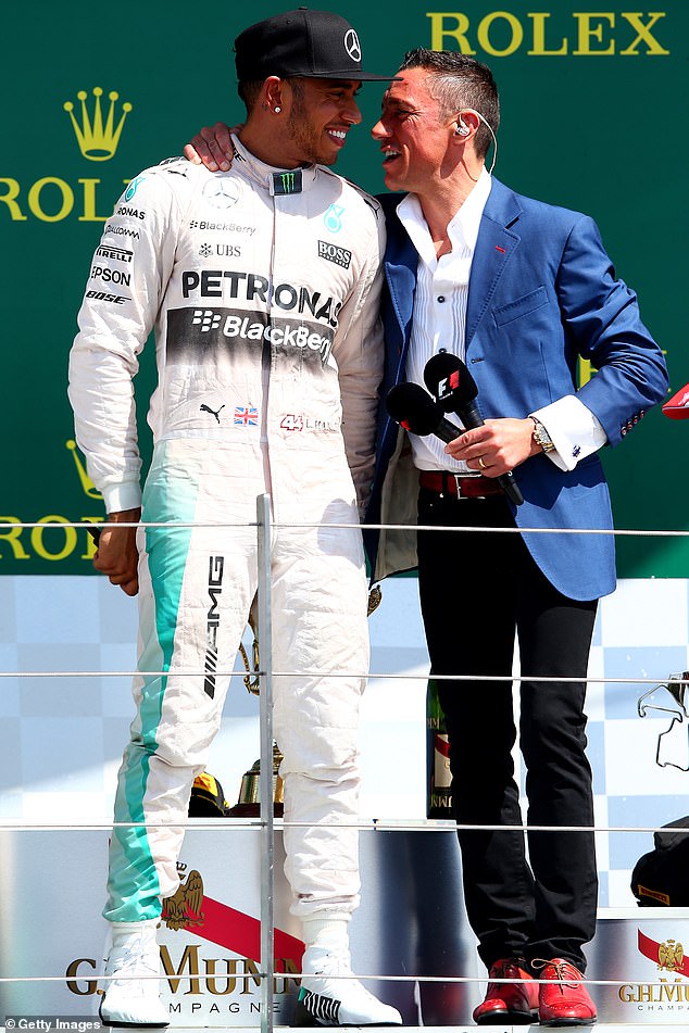Lewis Hamilton of Great Britain and Mercedes GP speaks with Frankie Dettori on the podium after his victory in the Formula One Grand Prix of Great Britain at Silverstone Circuit in 2015