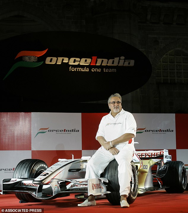 Pictured: Mallya posing with the Force India F1 car at its launch in 2008