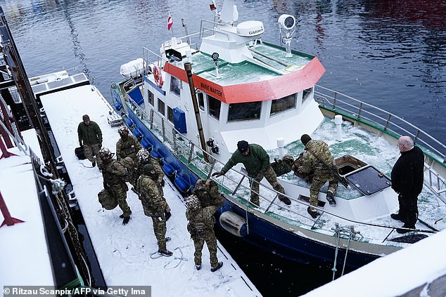 Danish soldiers disembark at the port in Nuuk, the capital of Greenland, yesterday