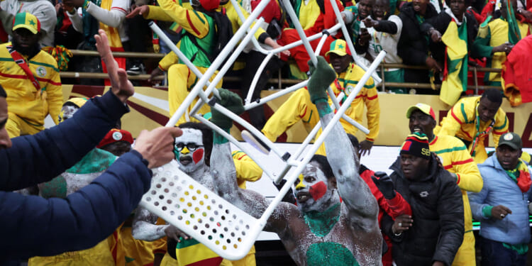 Fans in Senegal end storm pitch and throw chairs at police as Afcon final descends into chaos before Brahim Diaz penalty