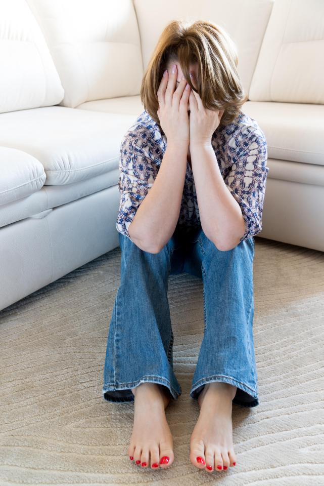 Woman in stress covered her face with her hands