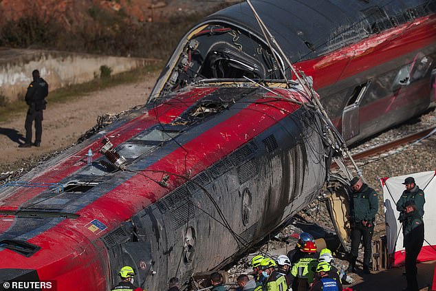 Picture shows the twisted train cars lying on their sides on Monday morning