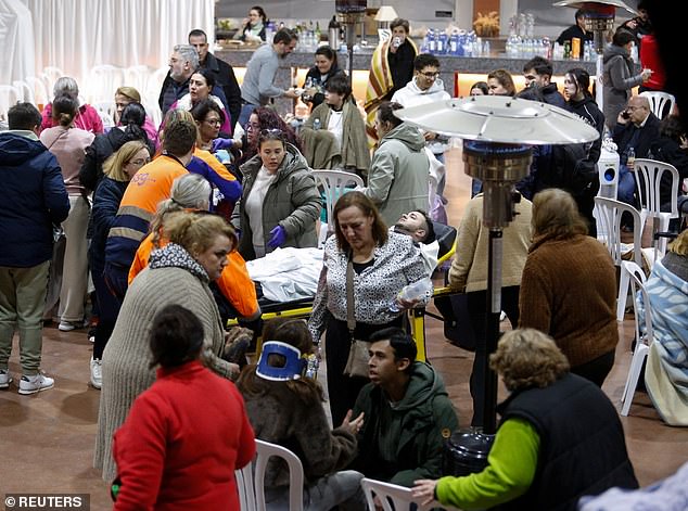 People affected by the deadly train derailment are transferred and treated at the Caseta Municipal in the town of Adamuz