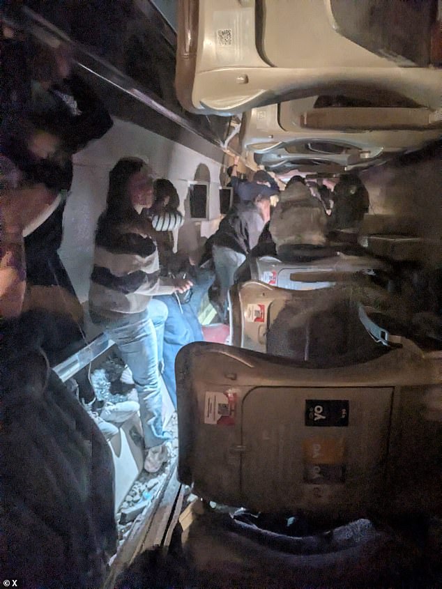 Screengrab shows the interior of one of the high-speed trains after it derailed as passengers wait to be evacuated