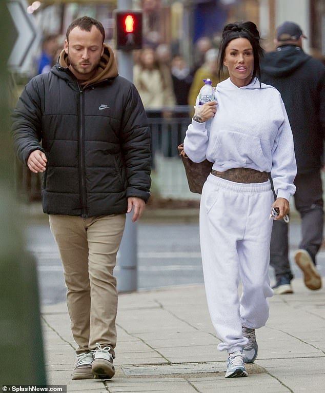 Despite the recent attention around her look, Katie was in high spirits as she headed out in her casual look with a male pal